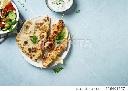 Chicken souvlaki kebabs and greek salad 116401557