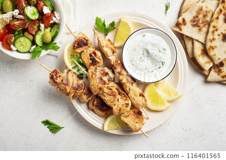 Chicken skewers ans greek vegetable salad Chicken skewers ans greek vegetable salad 116401565