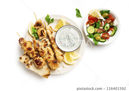 Grilled souvlaki skewers, greek salad and tzatziki Grilled souvlaki skewers, greek salad and tzatziki 116401592