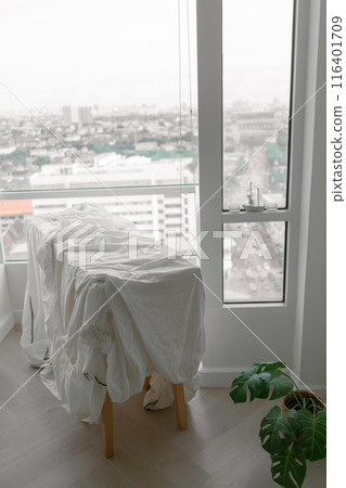 White bed sheets hanging after wash at the balcony in the apartment. 116401709