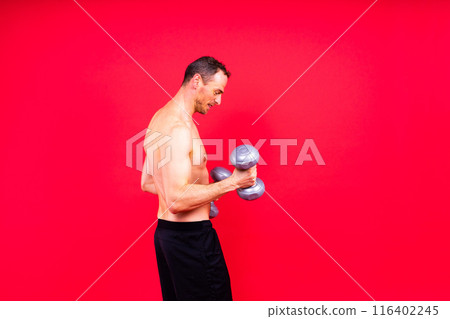 Bodybuilder exercising with dumbbells. Topless young man working out on studio background. Bodybuilder exercising with dumbbells. Topless young man working out on studio background. 116402245