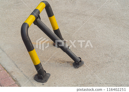 Metal access restrictor for the passage of the car, which can be lowered and raised, painted in black and yellow striped color. Metal access restrictor for the passage of the car, which can be lowered and raised, painted in black and yellow striped color. 116402251