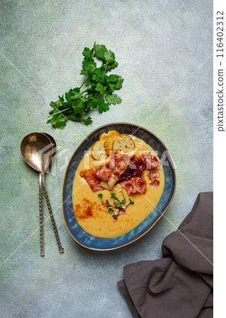 Pumpkin cream soup, curry, fried bacon, bruschetta chips,micro-greens, top view, no people, Pumpkin cream soup, curry, fried bacon, bruschetta chips,micro-greens, top view, no people, 116402312