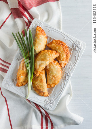 Fried chebureks, close-up, on a light background, no people, 116402318