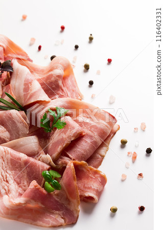 Raw bacon, sliced, with micro greenery and spices, on a white background, close-up, Raw bacon, sliced, with micro greenery and spices, on a white background, close-up, 116402331