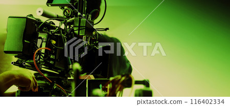 Film director and crew making commercial content advertising in studio. Filmmaker crew team with professional cinema equipment and video camera on the set. Technique of modern filming and advertising. 116402334