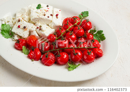 baked cherry tomatoes , with cheese, and spices, on a white plate, homemade, no people, baked cherry tomatoes , with cheese, and spices, on a white plate, homemade, no people, 116402373