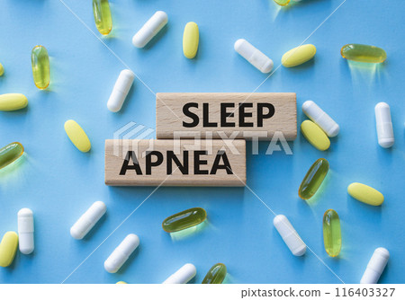 Sleep Apnea symbol. Concept word Sleep Apnea on wooden blocks. Beautiful blue background with pills. Medicine and Sleep Apnea concept. Copy space Sleep Apnea symbol. Concept word Sleep Apnea on wooden blocks. Beautiful blue background with pills. Medicine and Sleep Apnea concept. Copy space 116403327