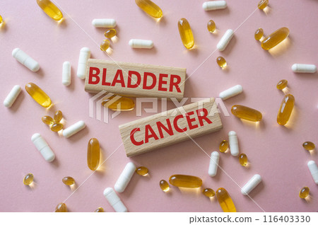 Bladder Cancer symbol. Concept word Bladder Cancer on wooden blocks. Beautiful pink background with pills. Medicine and Bladder Cancer concept. Copy space 116403330