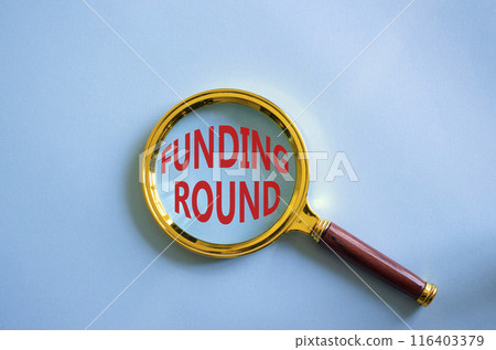 Funding Round symbol. Concept words Funding Round on magnifying glass. Beautiful blue background. Business and Funding Round concept. Copy space. Funding Round symbol. Concept words Funding Round on magnifying glass. Beautiful blue background. Business and Funding Round concept. Copy space. 116403379