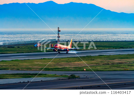 A passenger plane landing at Kobe Airport 116403417