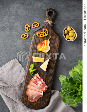 Assorted appetizers or antipasti. Wooden board with snacks. 116403845
