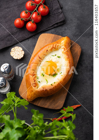 Adjarian khachapuri. Traditional Georgian food made from homemade bread with cheese and egg yolk Adjarian khachapuri. Traditional Georgian food made from homemade bread with cheese and egg yolk 116403857