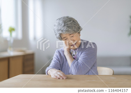 Senior woman holding her shoulder Senior woman holding her shoulder 116404157