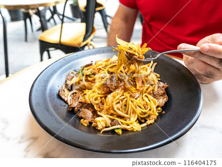 Udon Street Food on Fork Closeup, Chinese Fried Noodles, Beef Spaghetti with Vegetables in Hand Udon Street Food on Fork Closeup, Chinese Fried Noodles, Beef Spaghetti with Vegetables in Hand 116404175