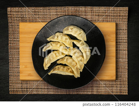 Gyoza Chinese Dumplings Top View, Vegetable Jiaozi, Chicken Momo Pile, Asian Gyoza Portion on Black 116404248