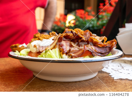 Polish Caesar salad with chicken, bacon and vegetables, high-calorie meat salad with fresh vegetables 116404278