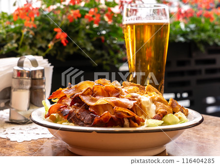 Polish Caesar salad with chicken, bacon and vegetables, high-calorie meat salad with fresh vegetables Polish Caesar salad with chicken, bacon and vegetables, high-calorie meat salad with fresh vegetables 116404285