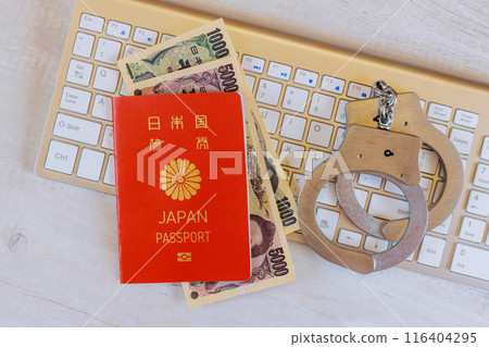 Law enforcement handcuffs on Japanese yen banknotes, Japan passport with computer keyboard technology Law enforcement handcuffs on Japanese yen banknotes, Japan passport with computer keyboard technology 116404295