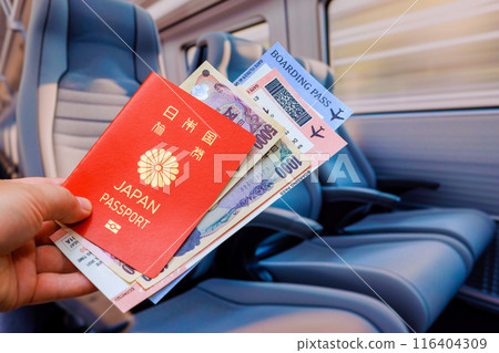 Passenger is holding Japanese yen banknote Japan passport, as well as tickets for train transfer to airport Passenger is holding Japanese yen banknote Japan passport, as well as tickets for train transfer to airport 116404309