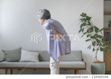 A woman in her 80s holding her waist A woman in her 80s holding her waist 116404348