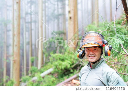 A male forestry worker looks relieved after completing the work safely 116404350
