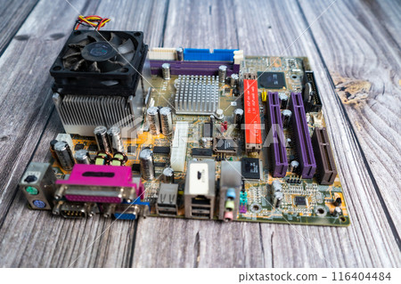 PC motherboard on a wooden table. 116404484