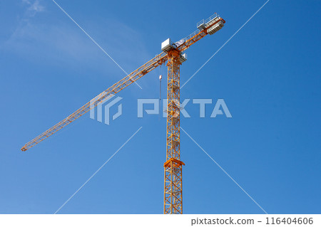 Yellow Construction Crane against Blue Sky 116404606
