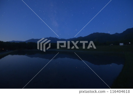 The Milky Way and Antares reflected in the night sky in Hakushu Town, Hokuto City on the surface of a rice field 116404618