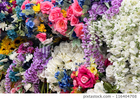 an assortment of vibrant, artificial flowers in various colors and types 116404708