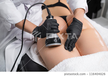 Body contouring with ultrasound cavitation is a procedure young women get at beauty salon Body contouring with ultrasound cavitation is a procedure young women get at beauty salon 116404826
