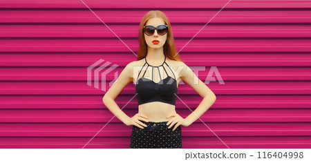 Beauty and fashion, stylish young woman posing in black outfit, glasses, girl model on pink wall 116404998