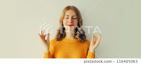 Calm relaxed healthy young woman meditates, girl practicing doing yoga exercises, stress relief Calm relaxed healthy young woman meditates, girl practicing doing yoga exercises, stress relief 116405063
