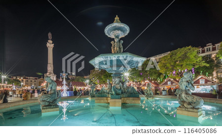 Panorama showing illuminated fountain with holiday decorations at the Rossio Christmas Market timelapse on Dom Pedro IV square. Lisbon, Portugal Panorama showing illuminated fountain with holiday decorations at the Rossio Christmas Market timelapse on Dom Pedro IV square. Lisbon, Portugal 116405086