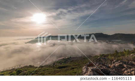 Panorama showing aerial View of Sesimbra Town and Port covered by fog timelapse, Portugal. 116405113