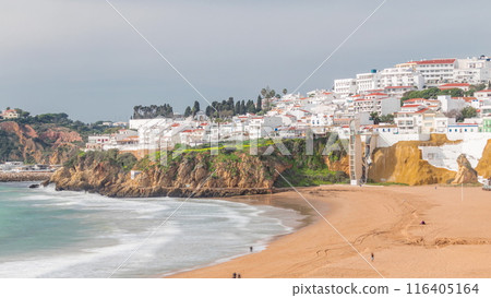 Wide sandy beach and Atlantic ocean in city of Albufeira timelapse. Algarve, Portugal 116405164