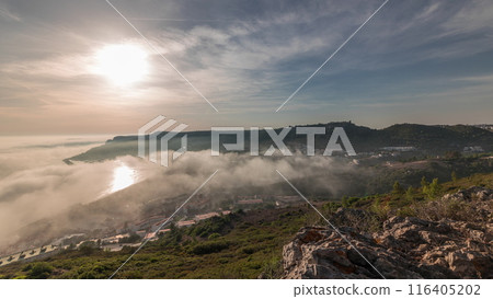 Panorama showing aerial View of Sesimbra Town and Port covered by fog timelapse, Portugal. Panorama showing aerial View of Sesimbra Town and Port covered by fog timelapse, Portugal. 116405202