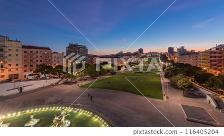 Panorama showing lawn at Alameda Dom Afonso Henriques and the Luminous Fountain aerial day to night timelapse in Lisbon. Panorama showing lawn at Alameda Dom Afonso Henriques and the Luminous Fountain aerial day to night timelapse in Lisbon. 116405204