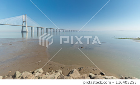 Motion from the low to high tide next to Vasco da Gama Bridge in Parque das Nacoes timelapse in Lisbon, Portugal. Motion from the low to high tide next to Vasco da Gama Bridge in Parque das Nacoes timelapse in Lisbon, Portugal. 116405255