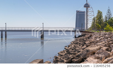 Motion from the low to high tide next to Vasco da Gama Bridge in Parque das Nacoes timelapse in Lisbon, Portugal. 116405256