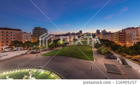 Panorama showing lawn at Alameda Dom Afonso Henriques and the Luminous Fountain aerial day to night timelapse in Lisbon. 116405257