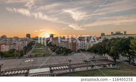 Panorama showing sunset over lawn at Alameda Dom Afonso Henriques and the Luminous Fountain aerial timelapse in Lisbon. 116405258