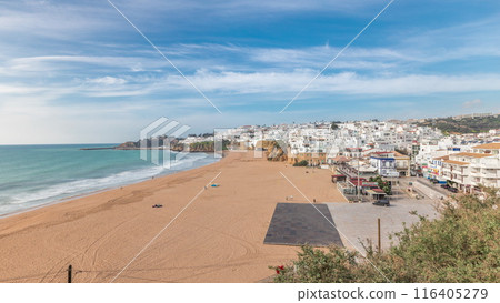 Wide sandy beach and Atlantic ocean in city of Albufeira timelapse. Algarve, Portugal 116405279