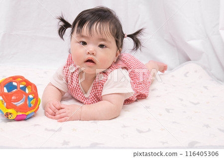 [Baby with twin tails starting to crawl] 116405306