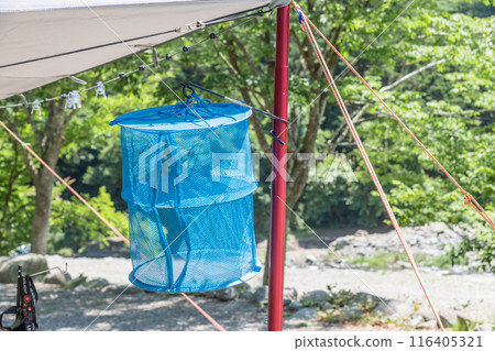 [Auto camping site: Tarp set up in the woods, hanging net] 116405321