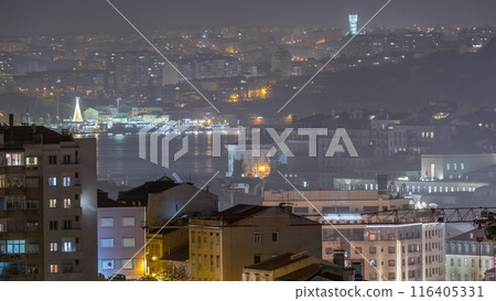 Aerial view of Lisboa downtown night timelapse. Panoramic of Baixa, Rossio and Chiado red rooftops from above. Portugal 116405331