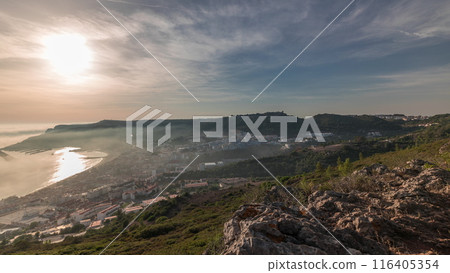 Panorama showing aerial View of Sesimbra Town and Port covered by fog timelapse, Portugal. 116405354