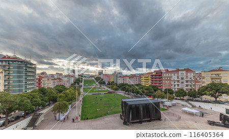 Panorama showing aerial view of Jardim da Alameda in Lisbon with the Luminous Fountain timelapse during sunset. 116405364