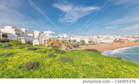 Wide sandy beach and Atlantic ocean in city of Albufeira timelapse. Algarve, Portugal 116405376