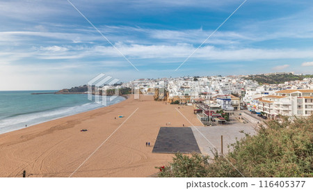 Wide sandy beach and Atlantic ocean in city of Albufeira timelapse. Algarve, Portugal 116405377